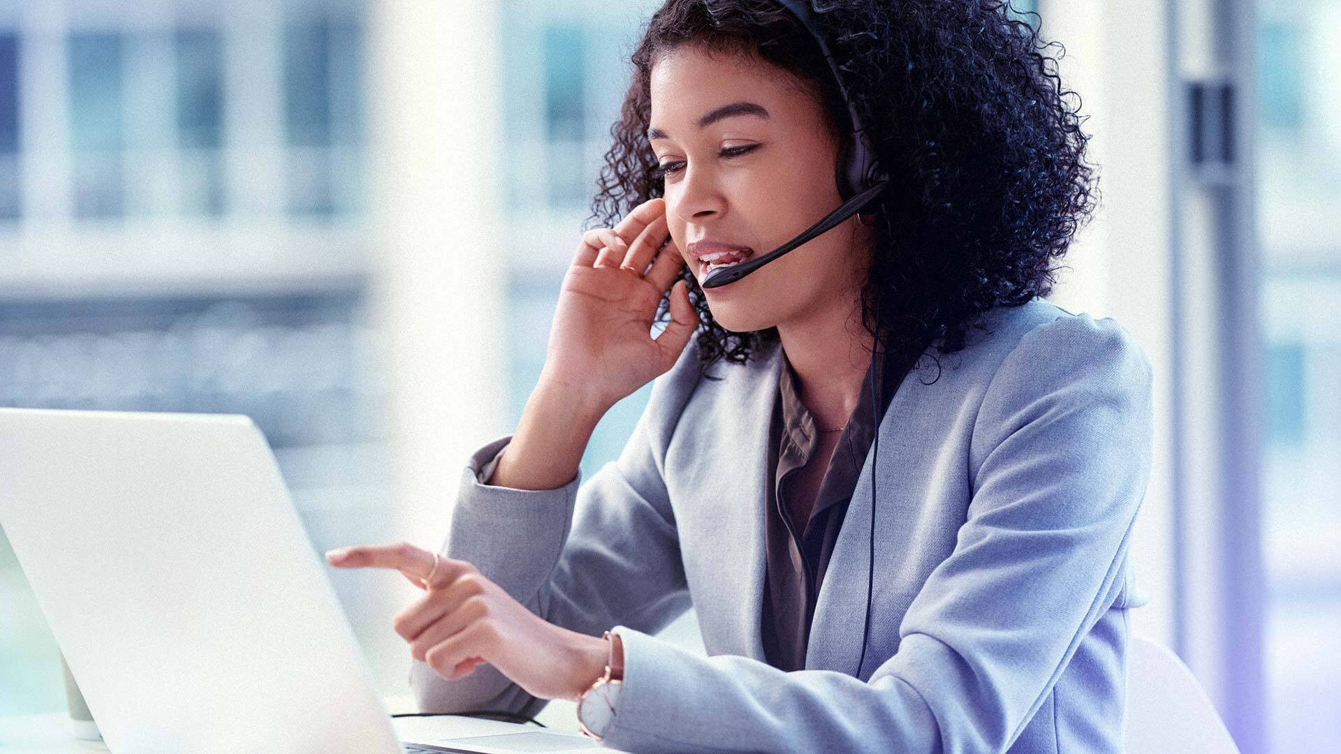 Woman in front of a computer talking on the phone